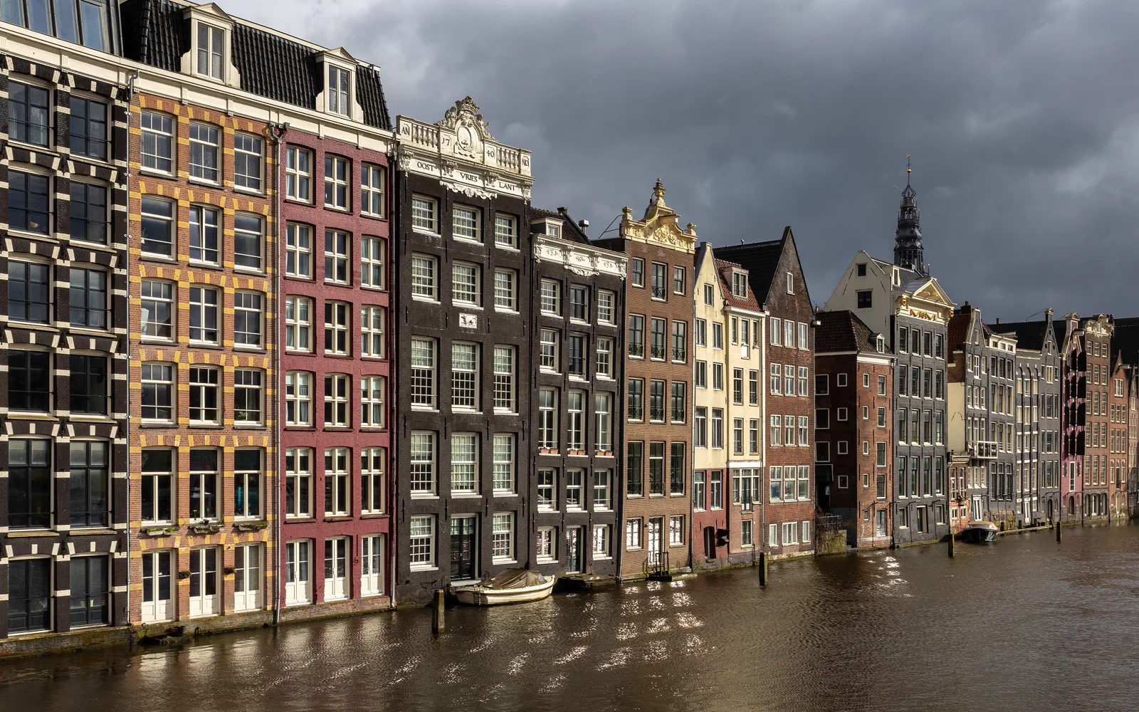 Golden-hour canal houses along Amsterdam's Damrak